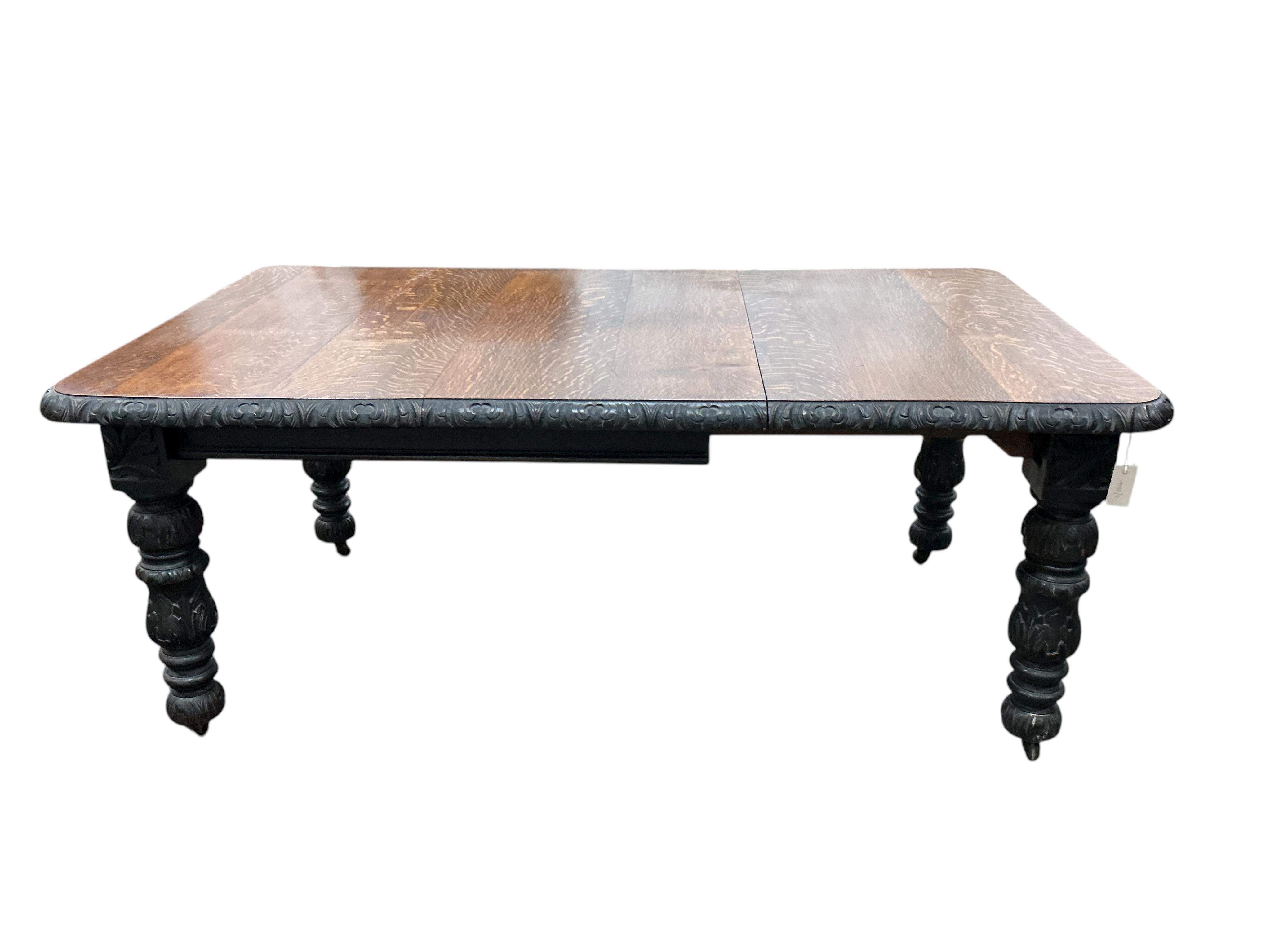 A late Victorian carved oak extending dining table, width 176cm extended, one spare leaf, depth 104cm, height 73cm